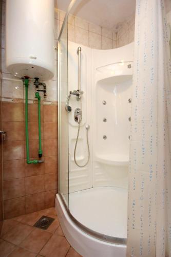 a shower with a glass door in a bathroom at Apartments with parking space Slano, Dubrovnik - 3184 in Slano