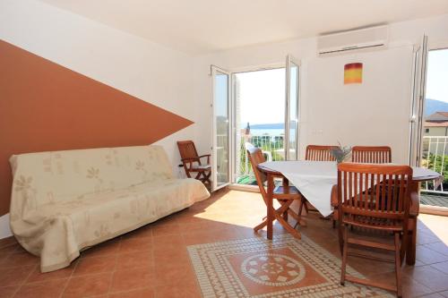 a living room with a couch and a table and chairs at Apartments with a parking space Slano, Dubrovnik - 3184 in Slano