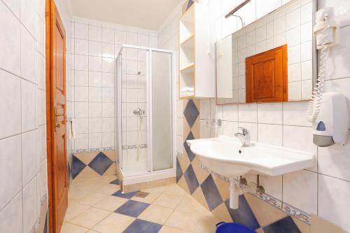 a bathroom with a sink and a shower at Apartments by the sea Rogoznica - 3196 in Rogoznica