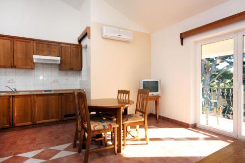 a kitchen and dining room with a table and chairs at Apartments by the sea Rogoznica - 3196 in Rogoznica