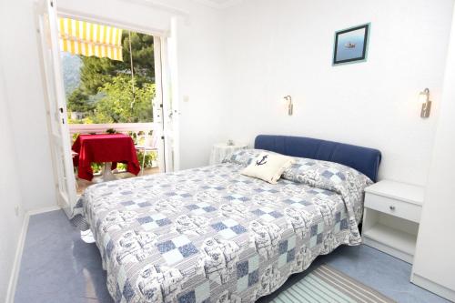 a small bedroom with a bed and a window at Double Room Zivogosce - Porat 2733a in Živogošće