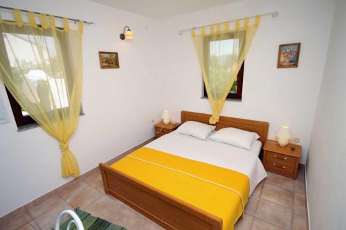 a bedroom with a bed and two windows at Studio Krk 3231a in Vrh