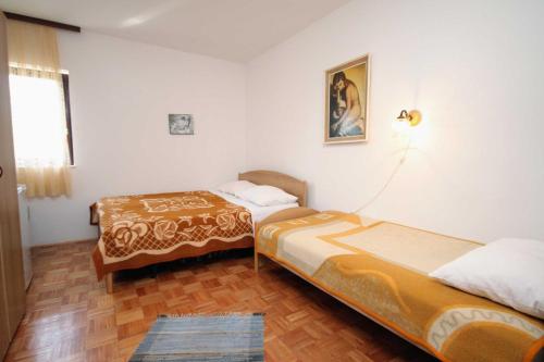 a room with two beds in a room at Triple Room Krk 3231a in Vrh