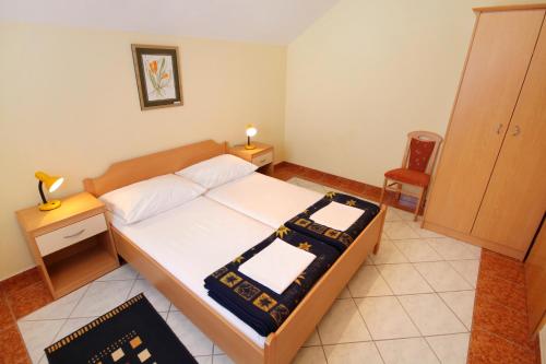 a bedroom with a bed and a table and a chair at Apartments with swimming pool Jadranovo, Crikvenica - 3238 in Jadranovo