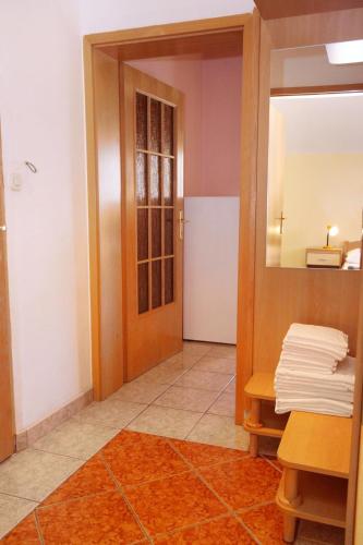a hallway with a bathroom with a mirror and a door at Apartments with swimming pool Jadranovo, Crikvenica - 3238 in Jadranovo