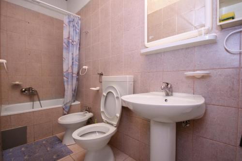 a bathroom with a toilet and a sink and a toilet at Apartments by the sea Selce, Crikvenica - 3240 in Selce
