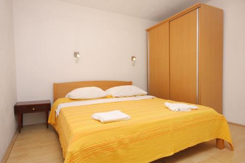 a bedroom with a bed with two towels on it at Family friendly seaside apartments Jagodna, Hvar - 3250 in Jelsa