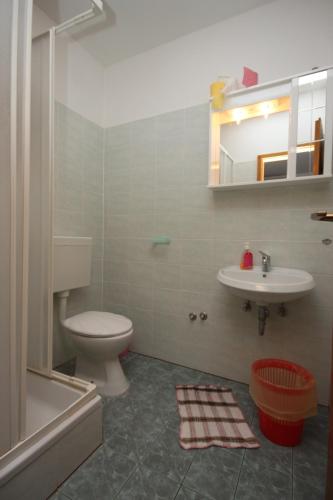 a bathroom with a toilet and a sink at Rooms by the sea Metajna, Pag - 3305 in Zubovići