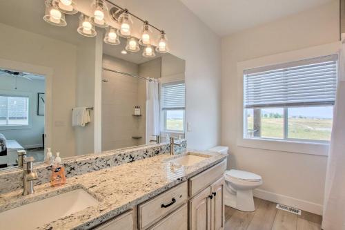 a bathroom with two sinks and a large mirror at Garden City Retreat with Access to Bear Lake! in Garden City