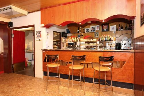 a bar with four stools in front of it at Rooms by the sea Racisce, Korcula - 3095 in Račišće