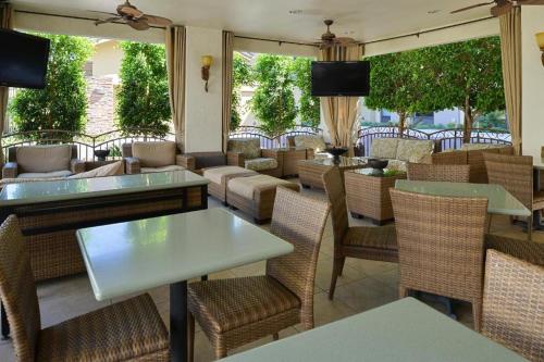 a restaurant with tables and chairs and windows at Baymont Inn & Suites by Wyndham Tempe University/Phoenix in Tempe