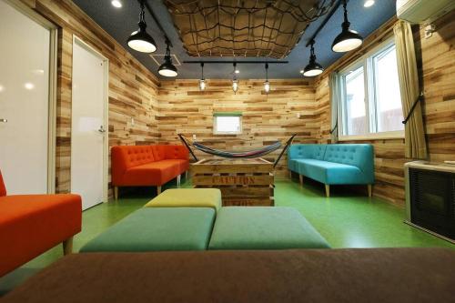 a room with chairs and a hammock in it at The BEEHIVE OTARU in Otaru