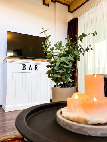 a table with a bar sign and candles in a room at Dovolenková chata Valča in Valča