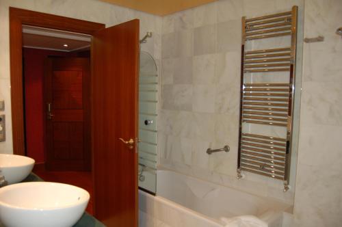 a bathroom with a sink and a shower with a mirror at Hotel La Casona de Lupa in San Juan de Piñera