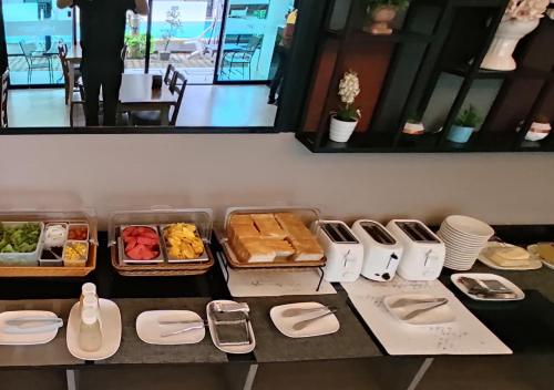 a table topped with plates and trays of food at J.P.GRAND HOTEL in Trat