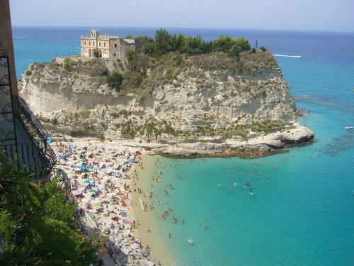 a group of people on a beach in the ocean at Hotel Virgilio in Tropea
