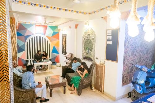 a group of people sitting in a living room at Citylights By MUSAFIR in Udaipur
