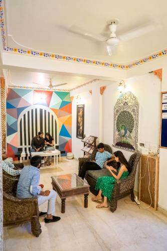 a group of people sitting in a living room at Citylights By MUSAFIR in Udaipur