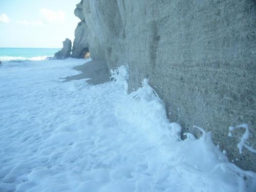 a beach with snow on the sand and the ocean at Hotel Virgilio in Tropea