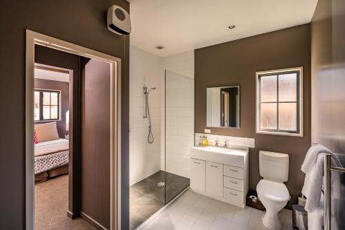 a bathroom with a shower and a toilet and a sink at Criffel Peak View Bed and Breakfast in Wanaka