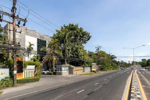 an empty street in a city with trees and buildings at Raya Beachloft in Rawai Beach