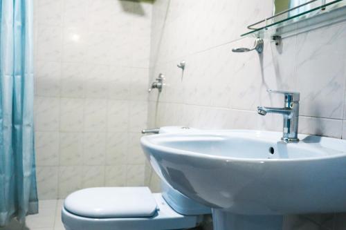 a bathroom with a sink and a toilet at Sitha's Heaven in Ella