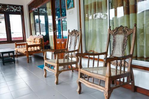 a group of chairs in a room with windows at Sitha's Heaven in Ella