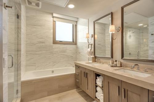 a bathroom with a tub and a sink and a shower at Premium Three Bedroom in Park City