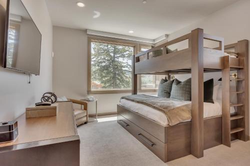 a bedroom with a bunk bed and a desk at Premium Three Bedroom in Park City