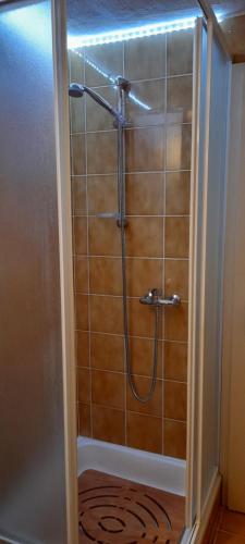 a shower with a hose in a bathroom at Anna's Home in Campione dʼItalia