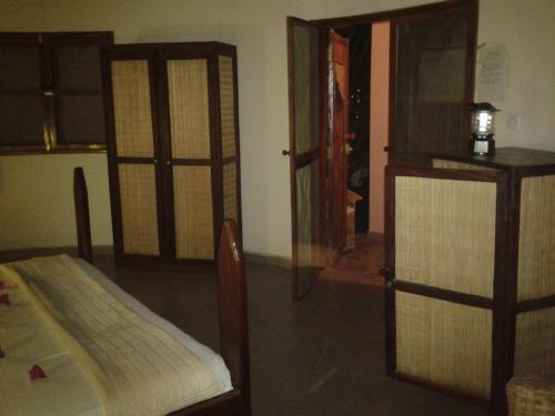 a bedroom with a bed and a glass door at Mandinka Lodge in Kololi
