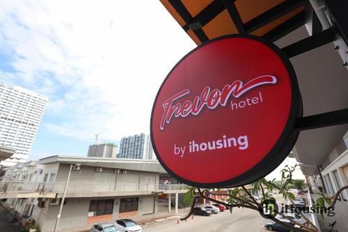 a red hotel sign hanging from the side of a building at Trevor Hotel Malacca Town By I Housing in Malacca