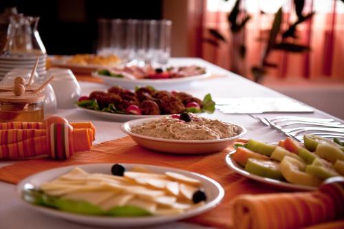 a table with plates of food on top of it at Pension Panorama in Odorheiu Secuiesc