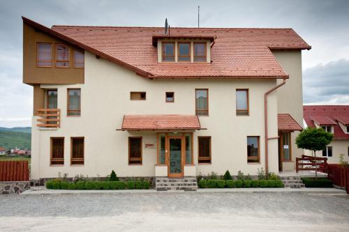 a large white house with a red roof at Pension Panorama in Odorheiu Secuiesc