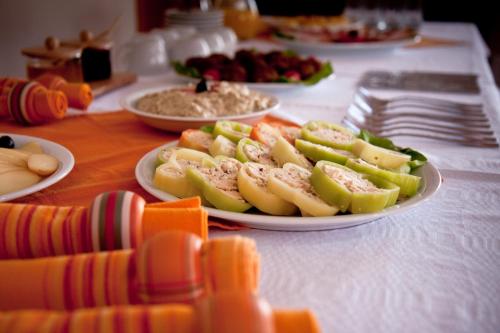 a table with plates of food on a table at Pension Panorama in Odorheiu Secuiesc