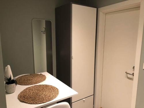 a room with a table with a mirror and a chair at Central studio apartment Apt 104 in Stavanger