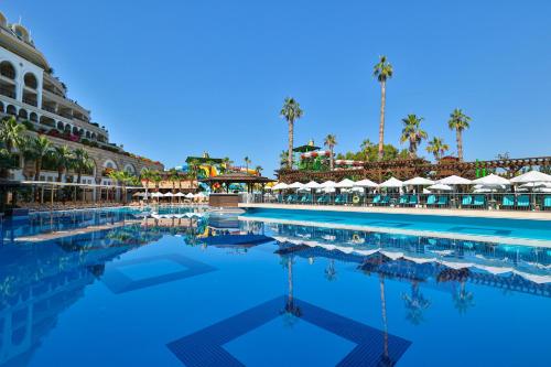 a pool at a resort with palm trees at Crystal Sunset Luxury Resort & Spa - Ultimate All Inclusive in Side