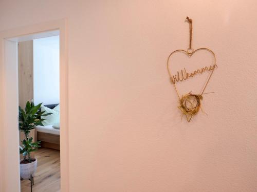 a heart shaped sign hanging on a wall at Apartment Auszeit in Gröbming
