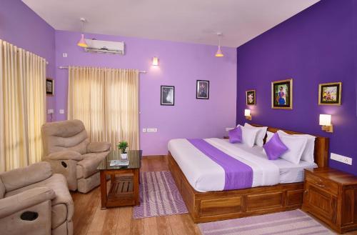 a bedroom with purple walls and a bed and a chair at Zenha Resorts in Munnar