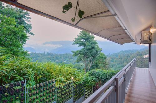 a balcony with a view of the mountains at Zenha Resorts in Munnar