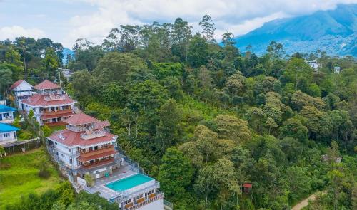an aerial view of a house in the forest at Zenha Resorts in Munnar
