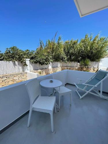a patio with two chairs and a table and a table at Zoumis Residence in Naousa