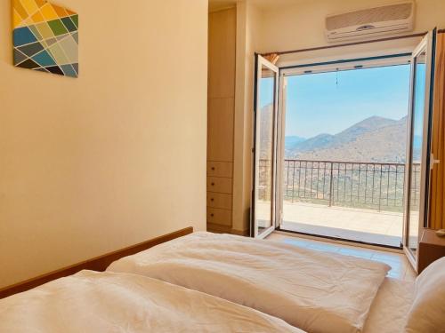a bedroom with a bed and a view of a balcony at Villa Oleander in Elounda
