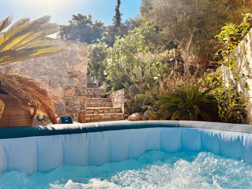 a swimming pool in a garden with a staircase at Villa Oleander in Elounda