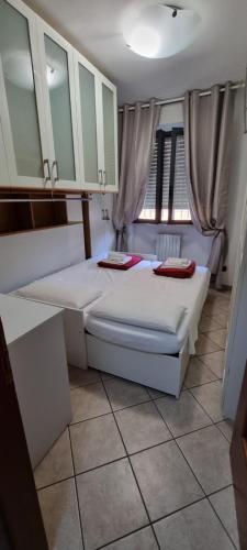 a bedroom with two beds and a table and cabinets at Chic & Relax apartment in Rimini
