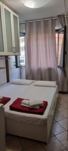 a bedroom with two beds with a towel on it at Chic & Relax apartment in Rimini