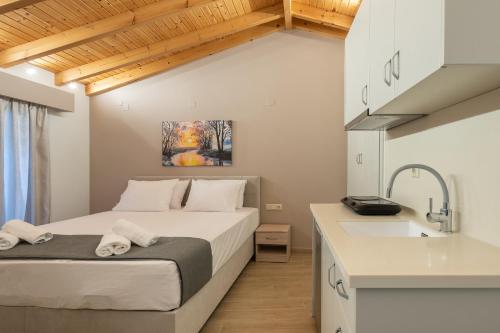 a bedroom with a bed and a sink at OLYMPIA ROOMS in Myrina