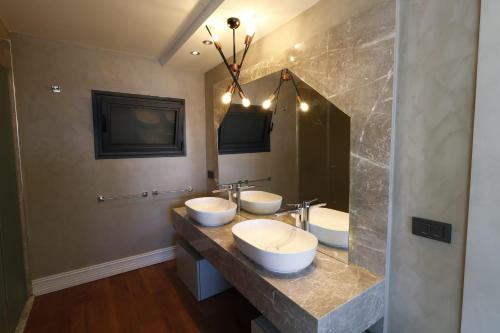 a bathroom with two sinks and a large mirror at Vistaport B - Luxury Villa in Bodrum City