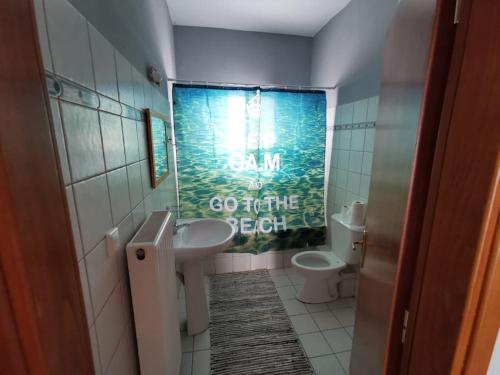 a bathroom with a sink and a toilet at Elli's House in Keramoti