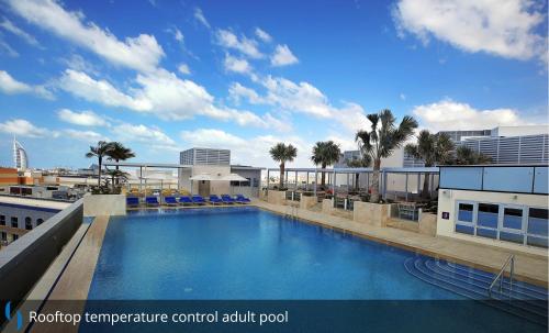 a swimming pool on the roof of a building at Grand Cosmopolitan Hotel in Dubai